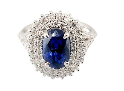 Anello in oro bianco 18K con doppio contorno di diamanti ct 1,12 e zaffiro blu ovale Ct 3,35